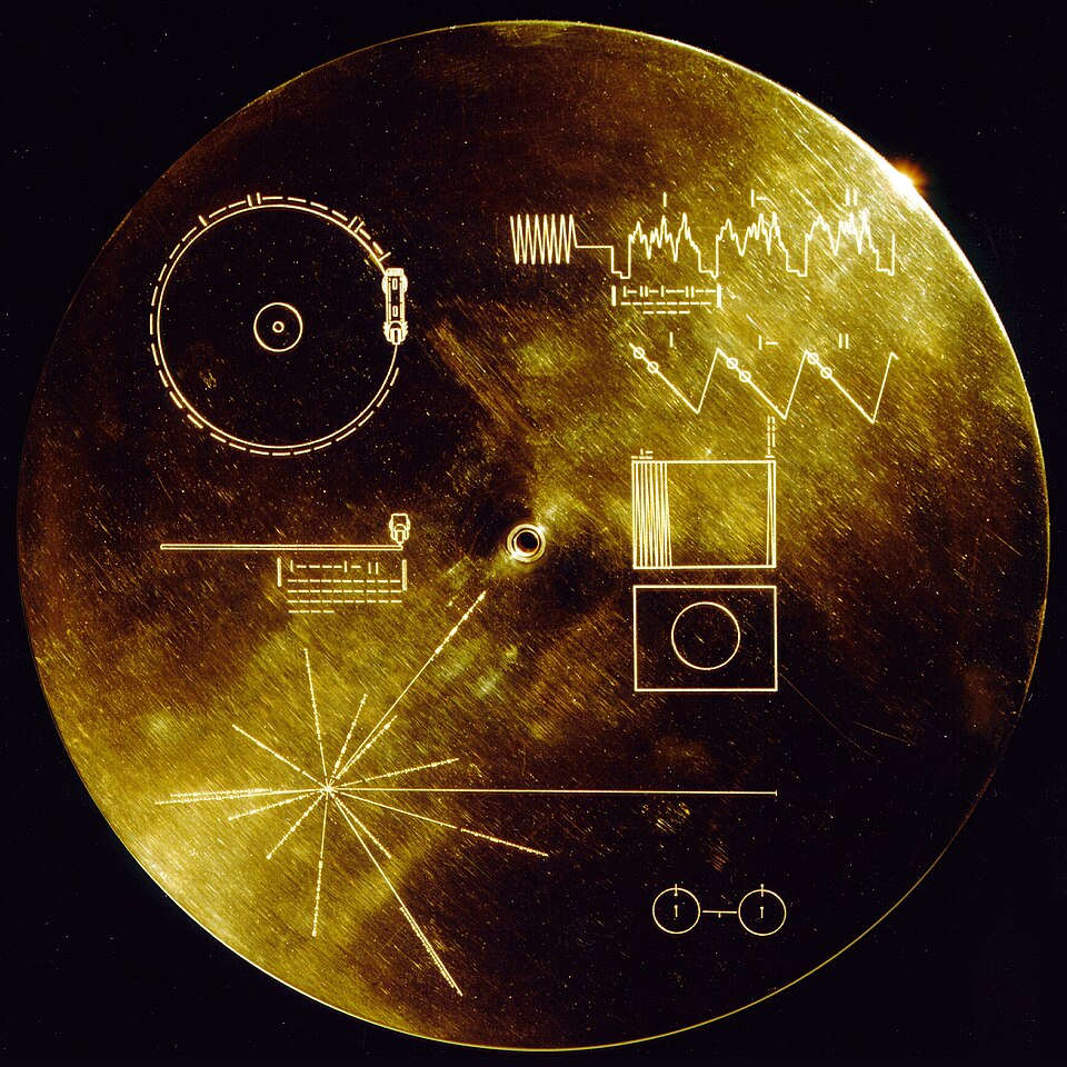 The Voyager Golden Record cover — a gold disc etched with playback instructions, a pulsar map, and a hydrogen atom